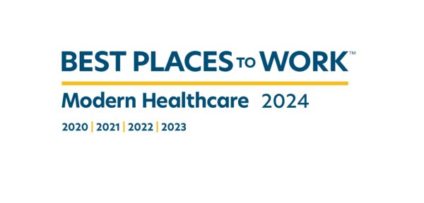 Text on the image says: "Best Places to Work - Modern Healthcare 2024. 2020 | 2021 | 2022 | 2023." The text is stylized with "Best Places to Work" in bold blue letters and underlined in yellow. "Modern Healthcare 2024" is in smaller blue text beneath the underline, highlighting a top-tier workplace for doctors and